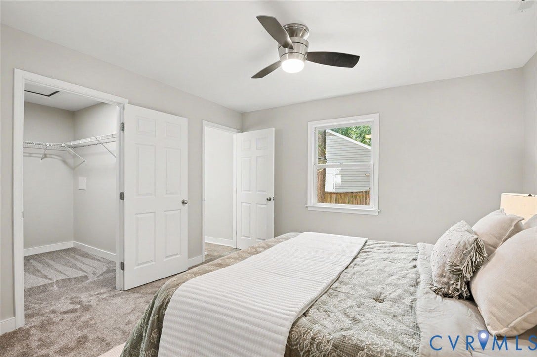 Neutral wall finishes, recessed window, ceiling fan with integrated lighting, and carpeted flooring