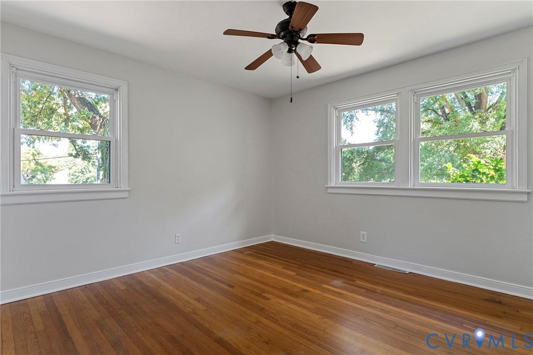5968 Forest Hill Avenue, Westlake Hills, Richmond, VA 23225 Hardwood flooring, painted walls, white trim, multiple windows, and a ceiling fan with integrated lighting