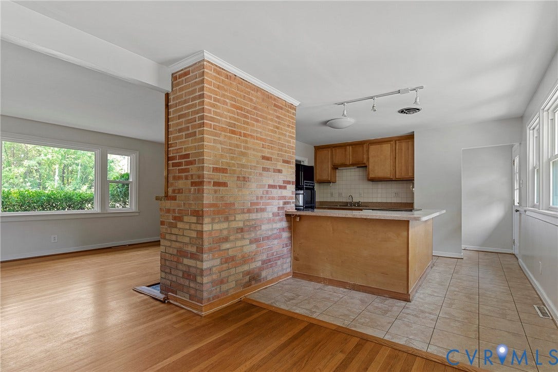 5968 Forest Hill Avenue, Westlake Hills, Richmond, VA 23225 Brick accent wall, wood-finish flooring, kitchen with wood cabinetry, tile flooring, and multiple windows