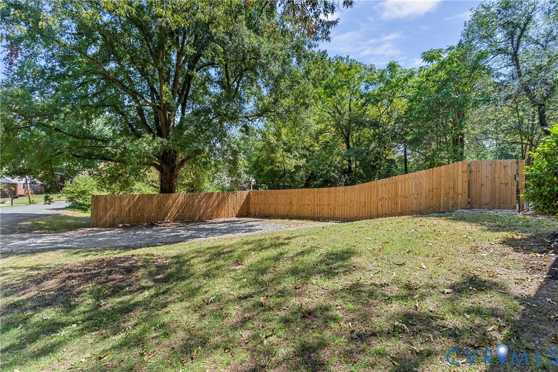 5968 Forest Hill Avenue, Westlake Hills, Richmond, VA 23225 Expansive grassy area with a wood privacy fence and mature trees