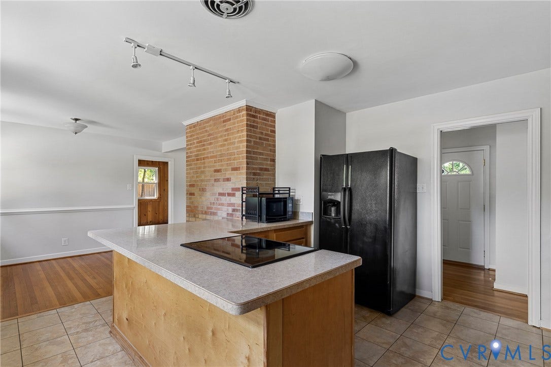 5968 Forest Hill Avenue, Westlake Hills, Richmond, VA 23225 Kitchen island with a built-in cooktop, brick accent column, track lighting, and tile flooring