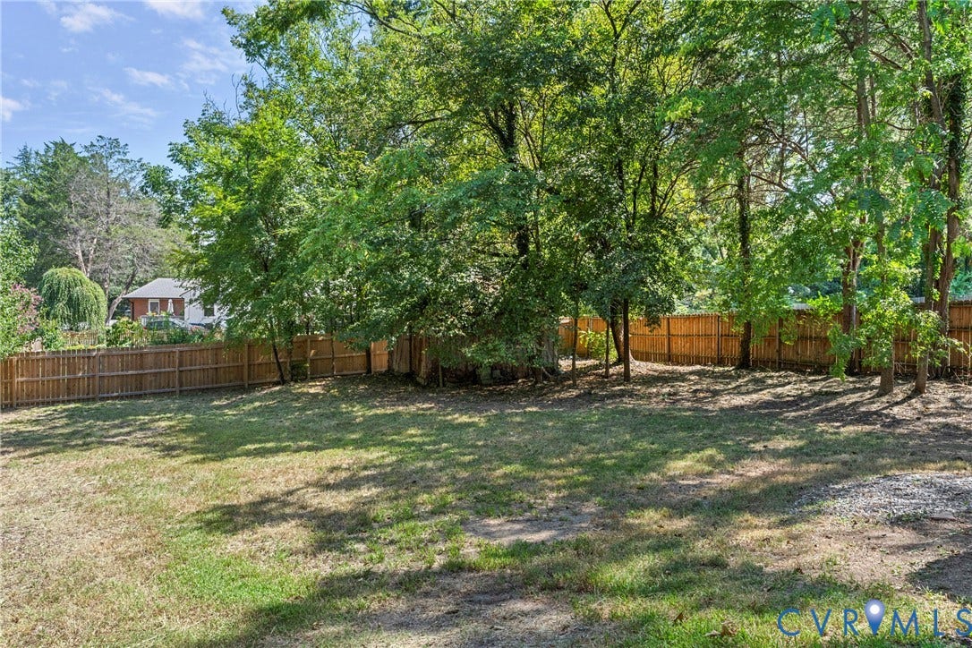 5968 Forest Hill Avenue, Westlake Hills, Richmond, VA 23225 Expansive grassy area with a wood privacy fence and mature trees