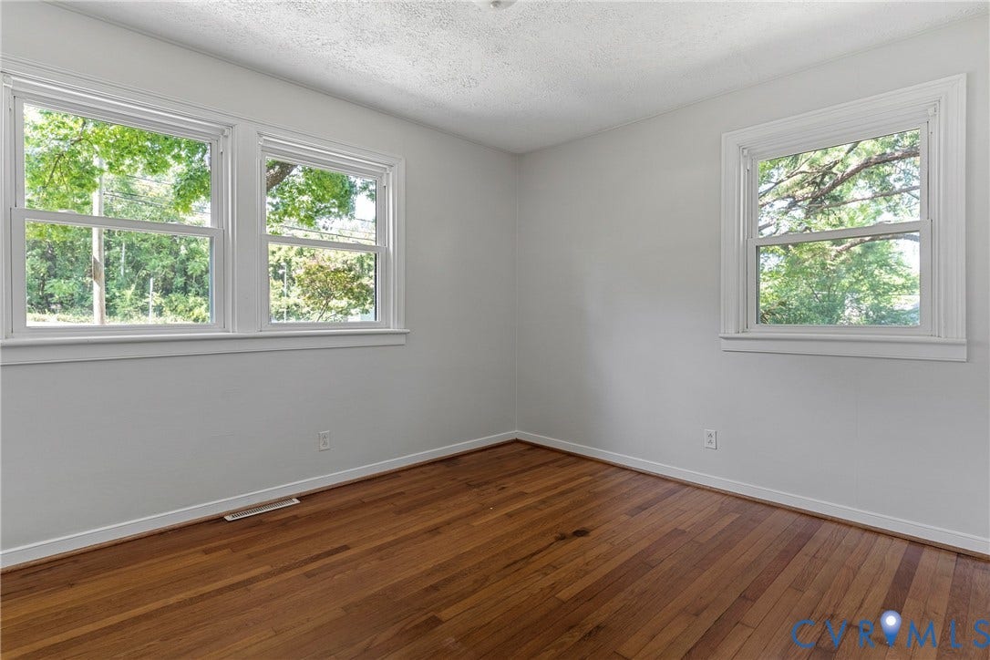 5968 Forest Hill Avenue, Westlake Hills, Richmond, VA 23225 Hardwood flooring, painted white walls, two double-hung windows, and a single-hung window