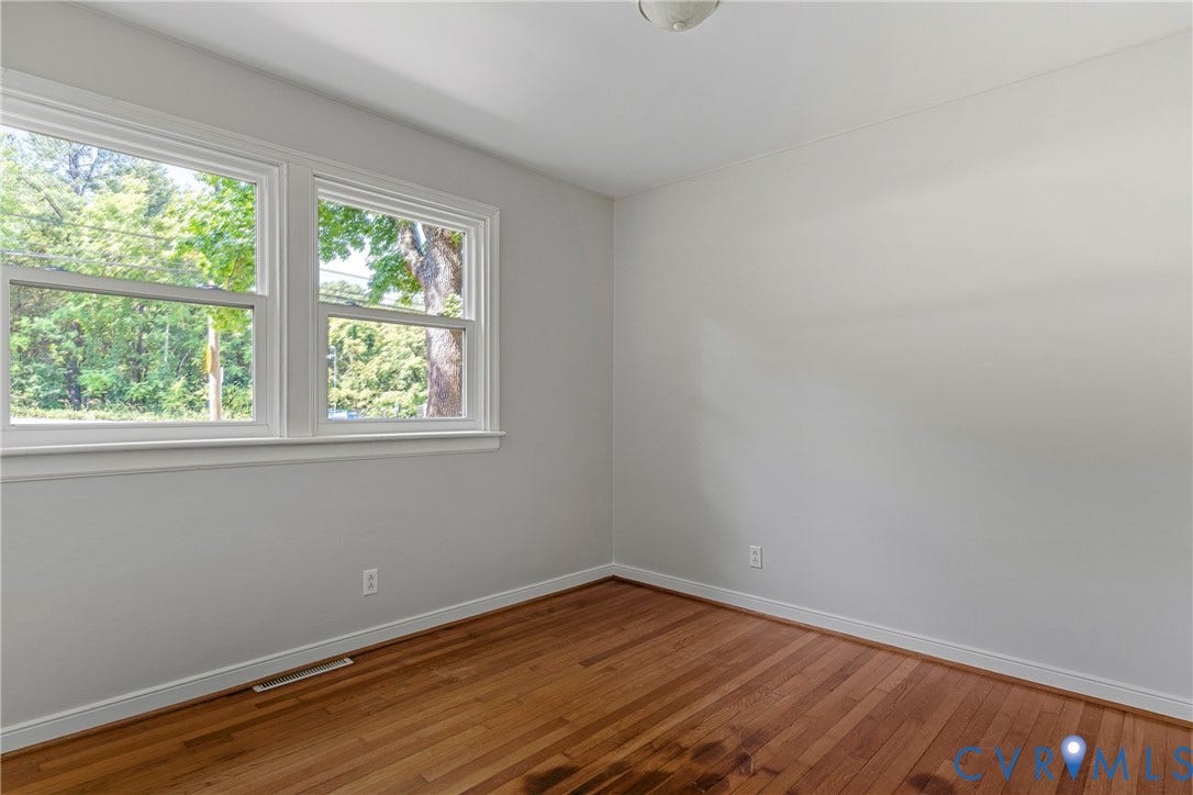 5968 Forest Hill Avenue, Westlake Hills, Richmond, VA 23225 Hardwood flooring, dual windows with white trim, light gray wall paint, and a ceiling-mounted light fixture