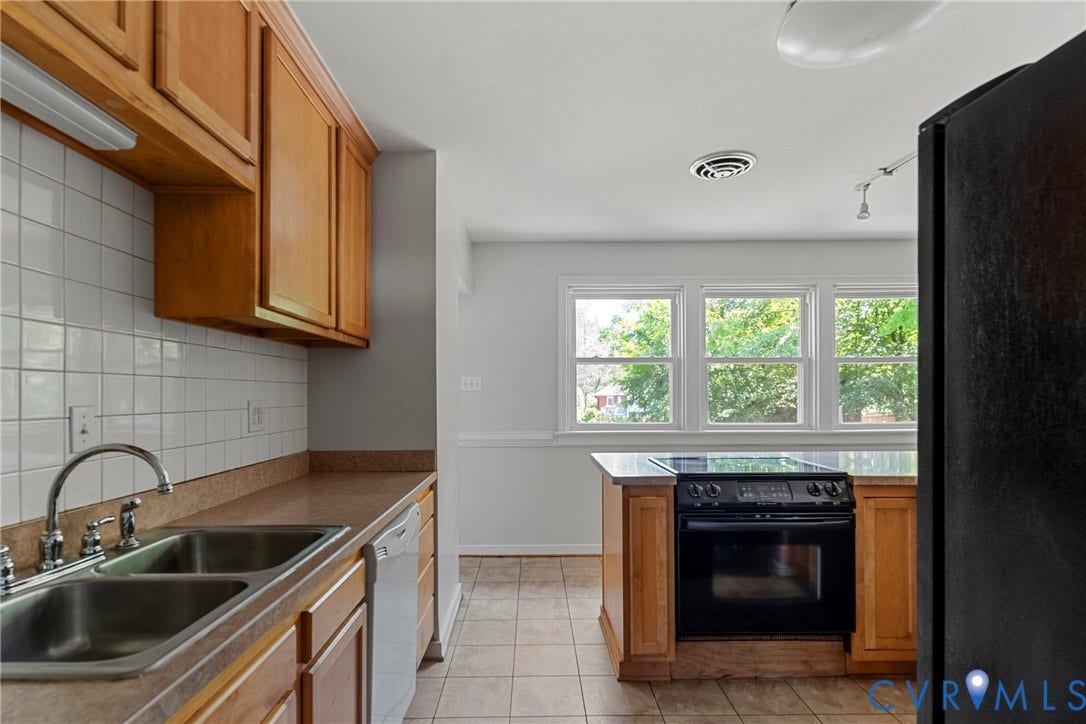 5968 Forest Hill Avenue, Westlake Hills, Richmond, VA 23225 Kitchen featuring wood cabinetry, a double basin stainless steel sink, a tile backsplash, and a black range