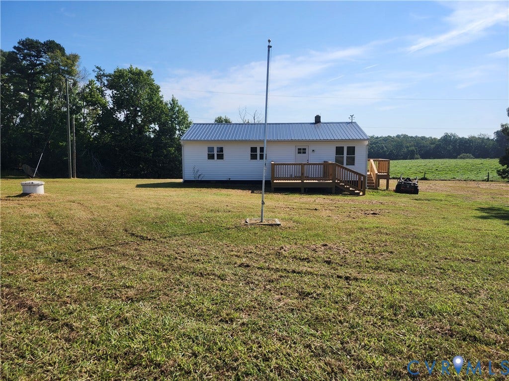 303 Putney Road, Cumberland, VA 23040 White siding exterior with a blue metal roof