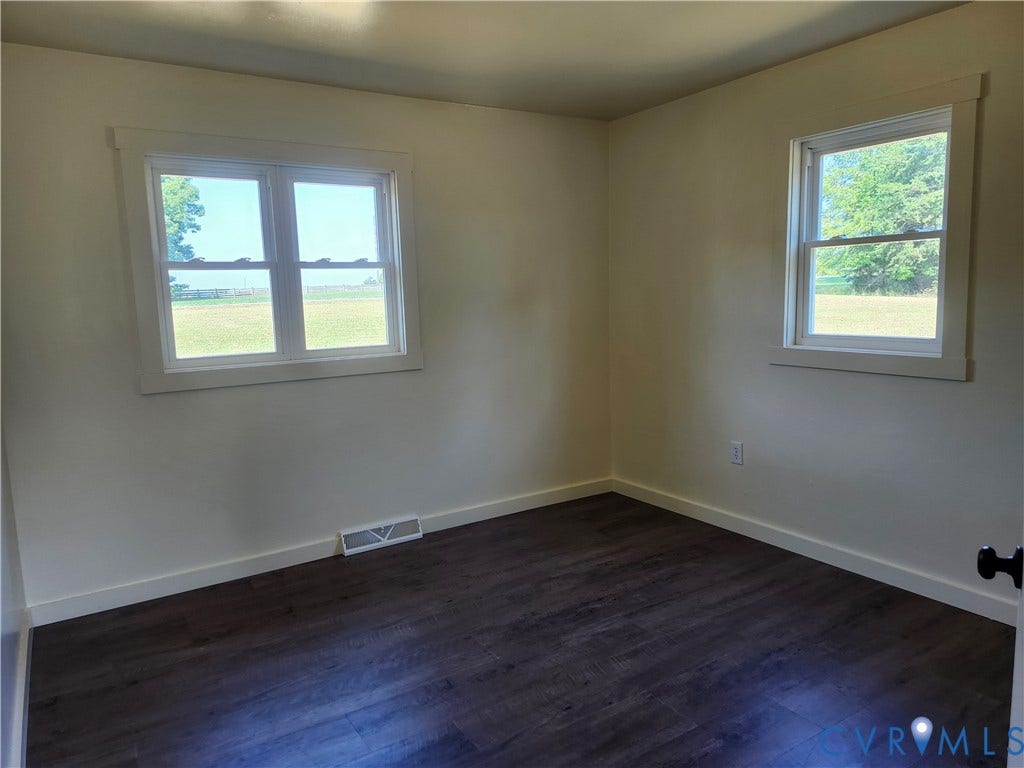 303 Putney Road, Cumberland, VA 23040 New flooring , light-toned walls, and multiple windows with white trim