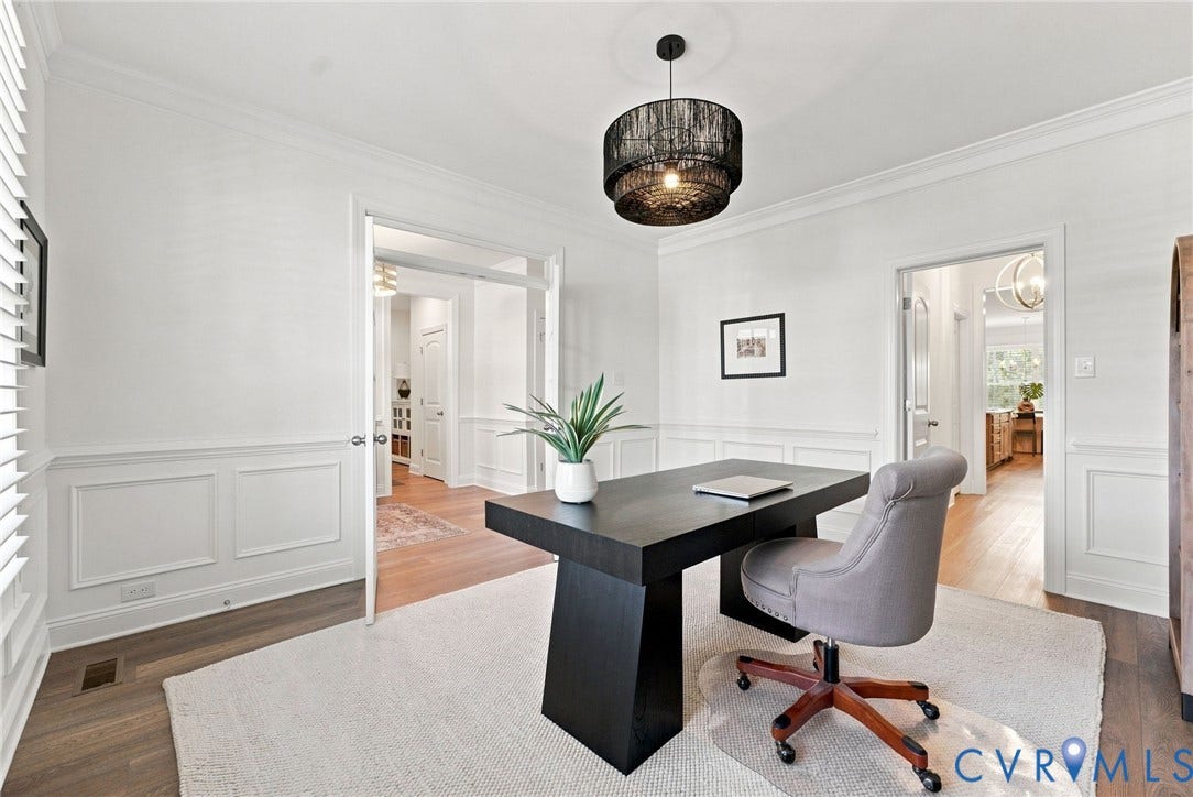 Hardwood flooring, crown molding, wainscoting, recessed lighting, and a contemporary light fixture