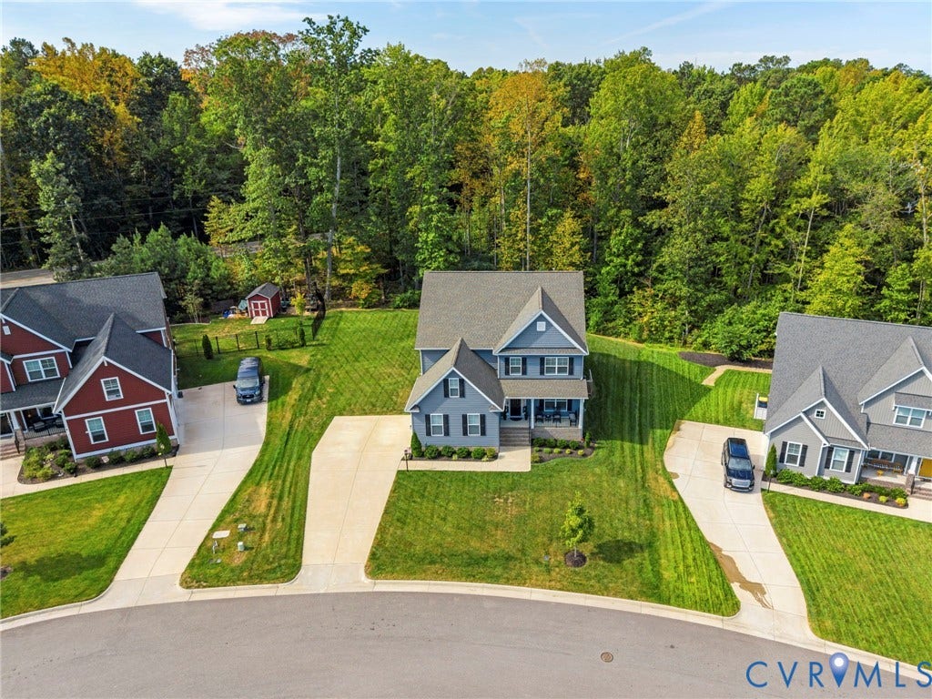 Contemporary two-story home featuring gray siding, a gable roof, and an inviting front porch
