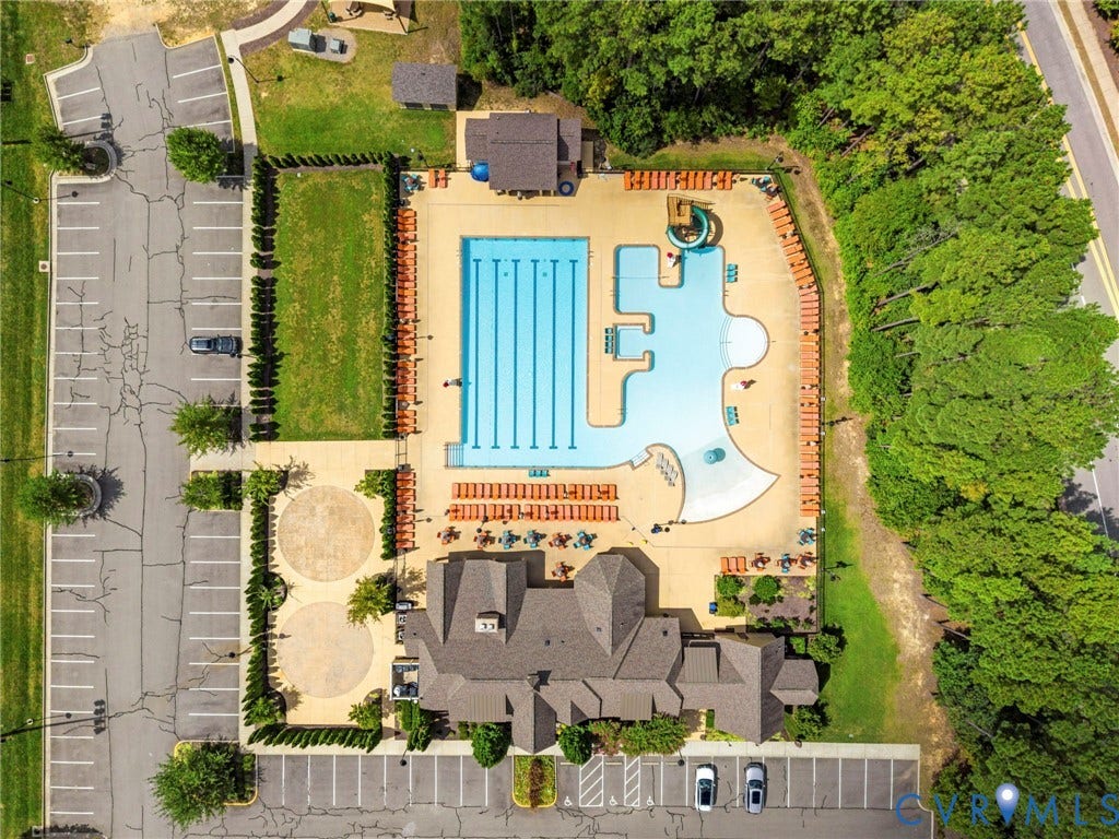 Expansive aquatic facility featuring a multi-lane lap pool, a freeform leisure pool, and surrounding lounge areas
