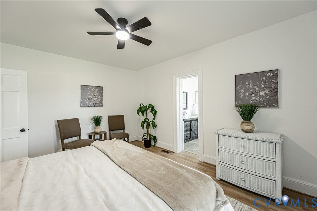 4008 River Road, Chesterfield, VA 23803 Ceiling fan with integrated lighting, wood-finish flooring, white trim, and a white door with dark hardware