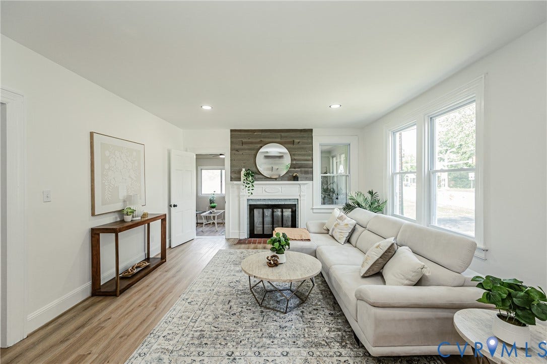 4008 River Road, Chesterfield, VA 23803 Recessed lighting illuminates wood-finish flooring and a central fireplace with a mantel and wood-paneled surround