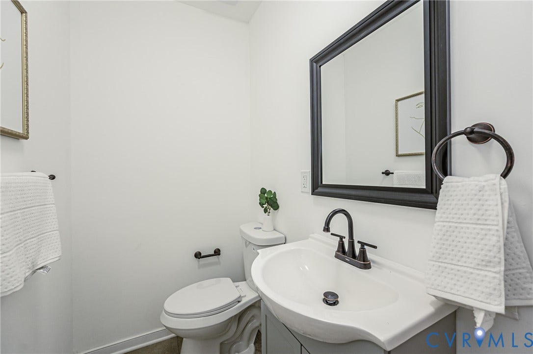 4008 River Road, Chesterfield, VA 23803 Powder room with pedestal sink, dark bronze fixtures, and framed mirror