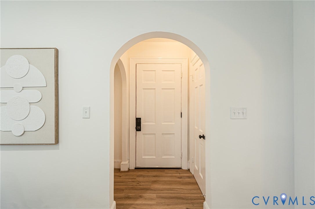 4008 River Road, Chesterfield, VA 23803 Arched doorway leading to an interior space with wood-finish flooring and a paneled door