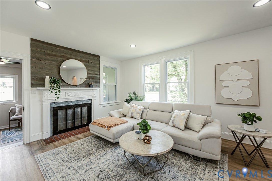 4008 River Road, Chesterfield, VA 23803 Fireplace with a wood surround and stone hearth, wood-finish flooring, recessed lighting, and multiple windows
