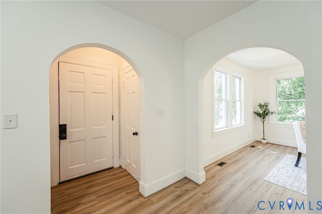 4008 River Road, Chesterfield, VA 23803 Archways providing architectural detail, wood-finish flooring, white paneled doors, and multiple windows