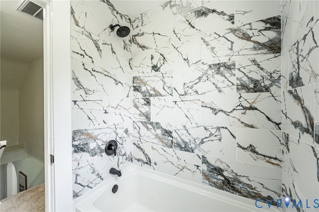 4008 River Road, Chesterfield, VA 23803 Tub and shower combination featuring black-finish fixtures