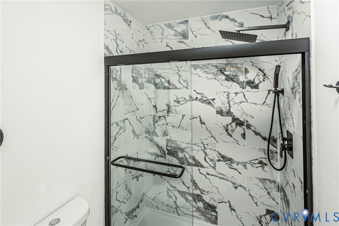 4008 River Road, Chesterfield, VA 23803 Glass-enclosed shower with matte black fixtures, rain shower head, and tiled walls