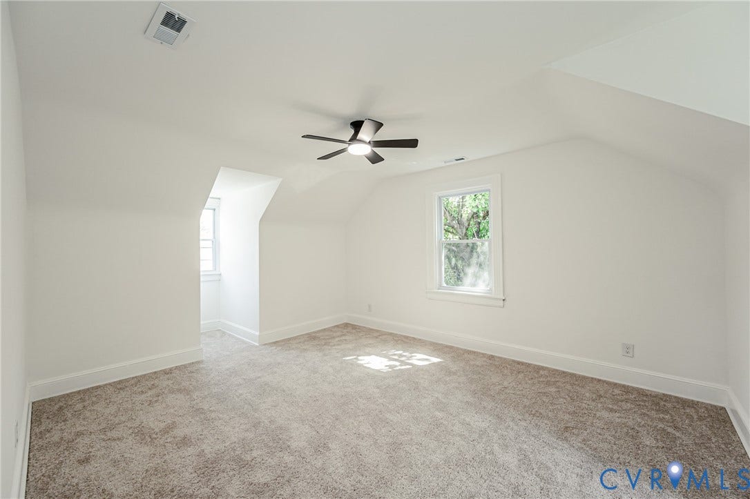 4008 River Road, Chesterfield, VA 23803 Carpeted room with a ceiling fan, two windows, and an angled ceiling