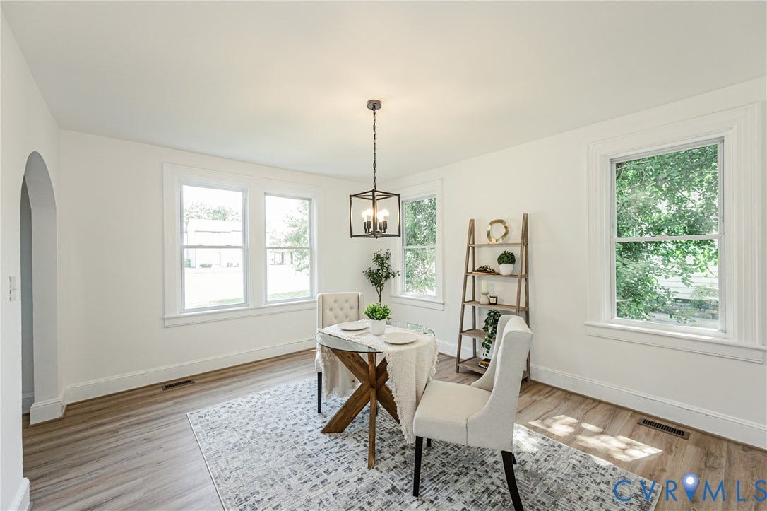 4008 River Road, Chesterfield, VA 23803 Archway entry with white trim, wood-finish flooring, multiple windows, and a ceiling-mounted light fixture