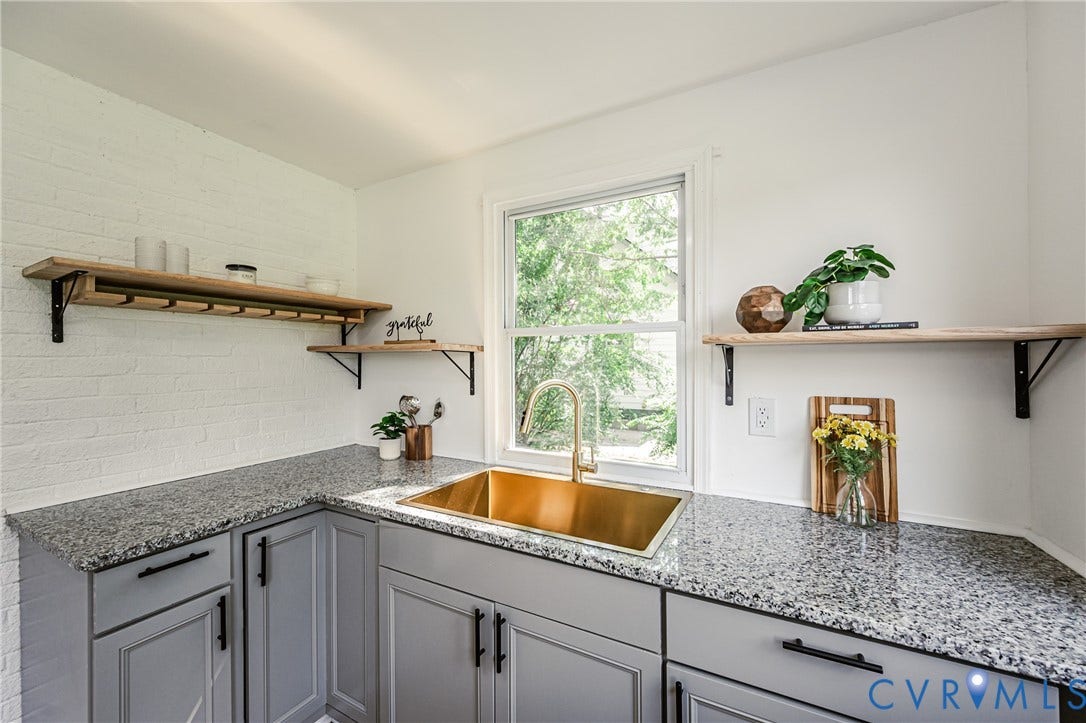 4008 River Road, Chesterfield, VA 23803 Granite countertops, a gold-tone basin sink with a matching faucet, gray cabinetry with black hardware, and open wood shelving
