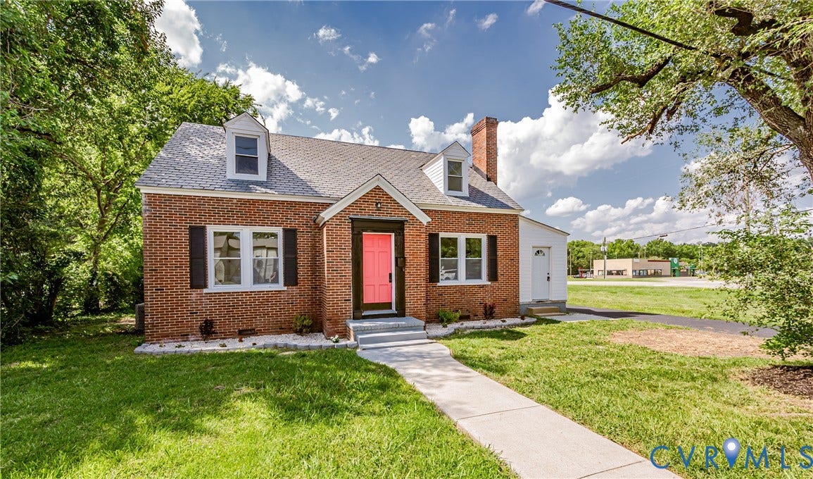 4008 River Road, Chesterfield, VA 23803 Brick exterior with a prominent chimney, dormer windows, and a vibrant entry door