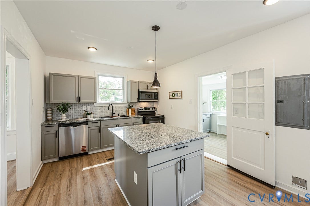4008 River Road, Chesterfield, VA 23803 Kitchen featuring wood-finish flooring, gray cabinetry, granite countertops, a tiled backsplash, and a central island