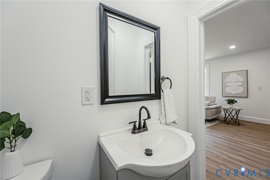 4008 River Road, Chesterfield, VA 23803 Vanity with an integrated sink, framed mirror, and dark-finish faucet