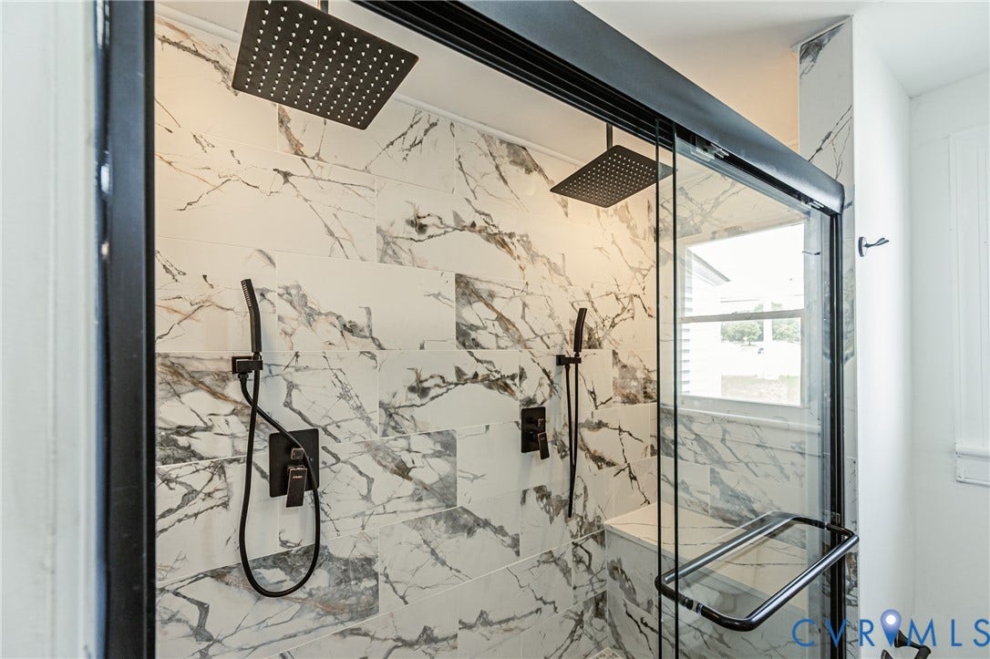 4008 River Road, Chesterfield, VA 23803 Tiled shower enclosure featuring a dual rain shower head system and handheld sprayer