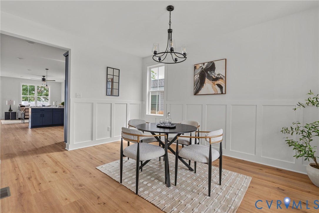 2004 Newbourne Street, Richmond, VA 23223 Dining area featuring wood-finish flooring, wainscoting, and a multi-light chandelier