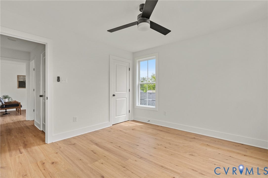 2004 Newbourne Street, Richmond, VA 23223 Wood-finish flooring, white walls, black ceiling fan, white trim, and a double-pane window