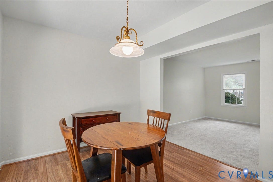 1555 Skirmish Run Drive, #1555, Henrico, VA 23228 Wood-finish flooring, overhead pendant lighting, and a broad cased opening to a separate carpeted room