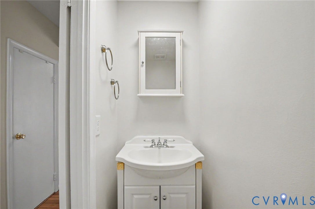1555 Skirmish Run Drive, #1555, Henrico, VA 23228 White vanity with an integrated sink and chrome faucet