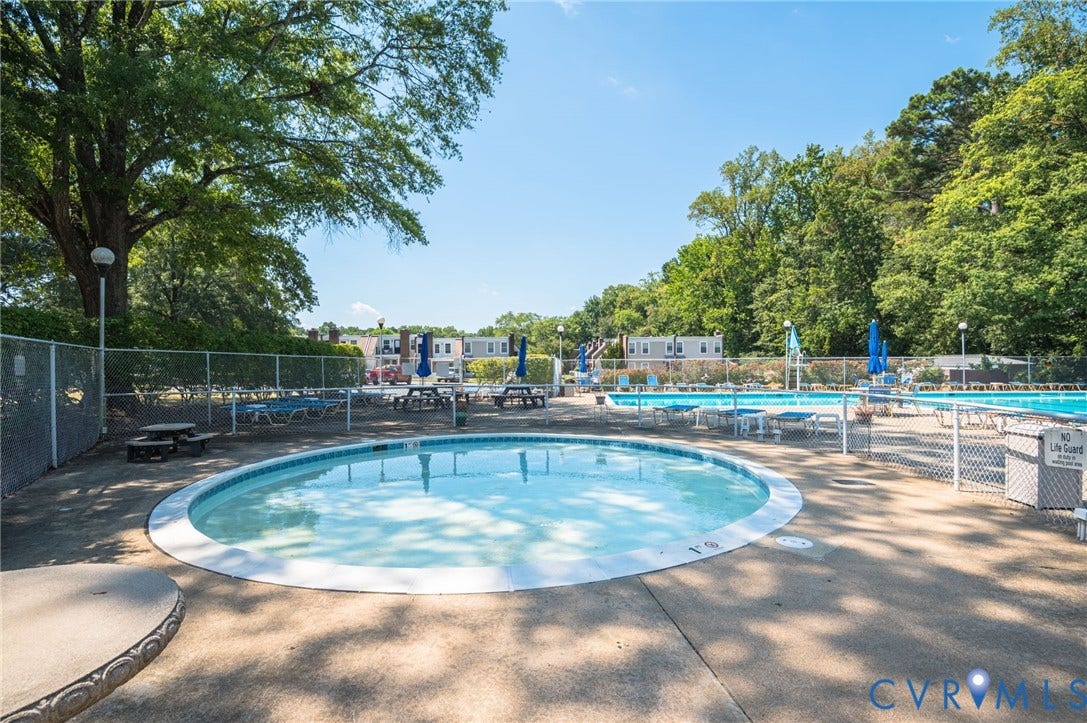1555 Skirmish Run Drive, #1555, Henrico, VA 23228 Resort-style pool area featuring a circular shallow pool, a larger rectangular pool, and surrounding concrete decking