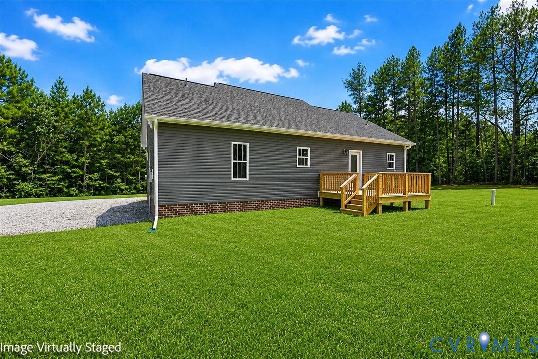 3289 Cumberland Road, Cumberland, VA 23040 Exterior with dark green siding, white-trimmed windows, a dark shingle roof, and a wood deck