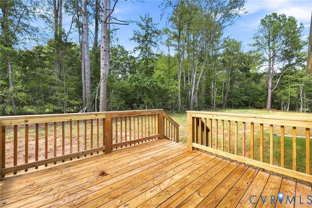 3289 Cumberland Road, Cumberland, VA 23040 Cottage-style home featuring a covered front porch, dark siding, white trim, and a gravel driveway
