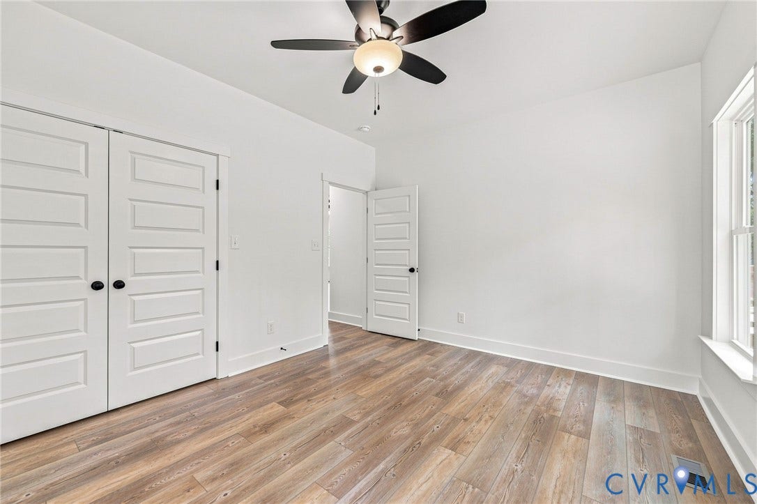3289 Cumberland Road, Cumberland, VA 23040 Expansive wood-finish deck with a wood railing system, offering clear sightlines to the surrounding wooded area and green lawn