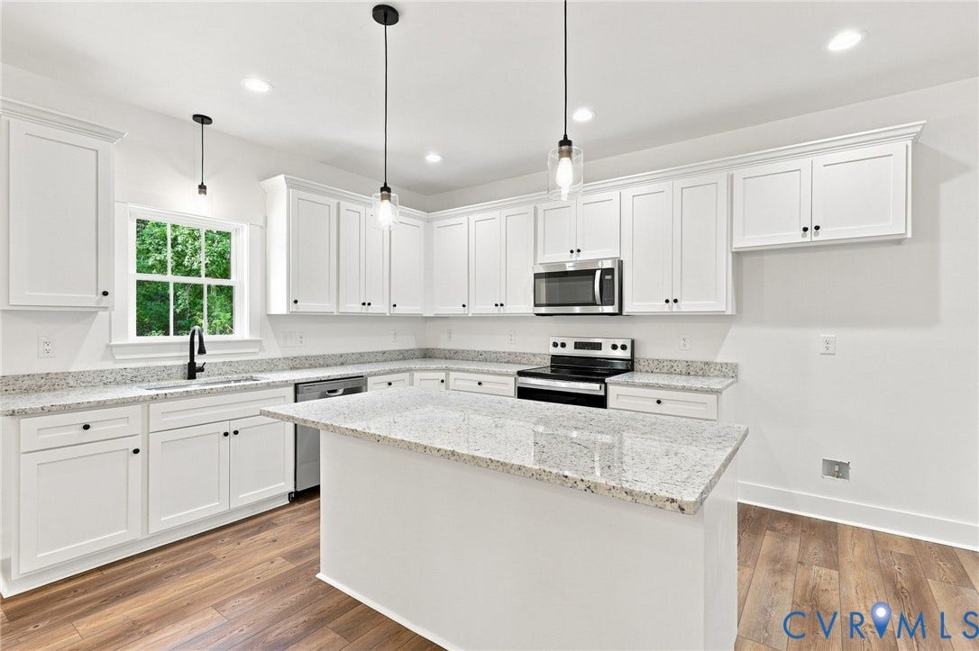 3289 Cumberland Road, Cumberland, VA 23040 Open-concept living space with wood-finish flooring, recessed lighting, and white cabinetry