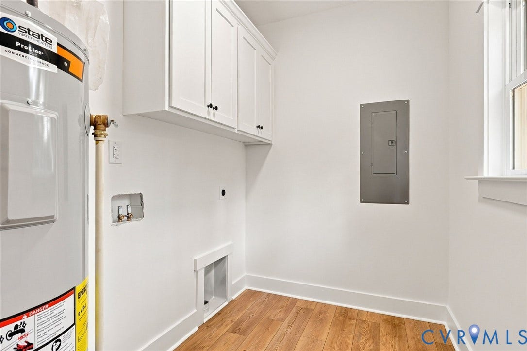 3289 Cumberland Road, Cumberland, VA 23040 Spacious room featuring wood-finish flooring, white walls, two double-hung windows, and a ceiling fan with integrated lighting