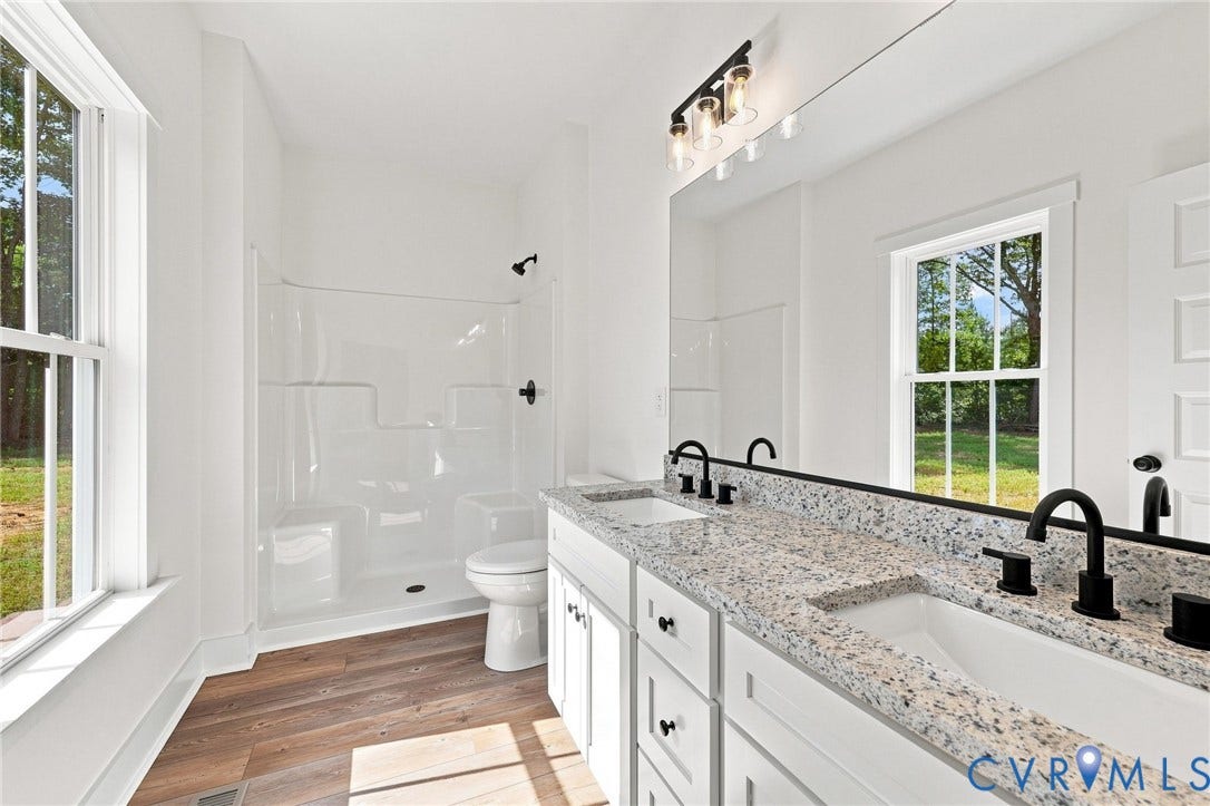 3289 Cumberland Road, Cumberland, VA 23040 Wood-finish flooring, white walls, and a ceiling fan with integrated lighting