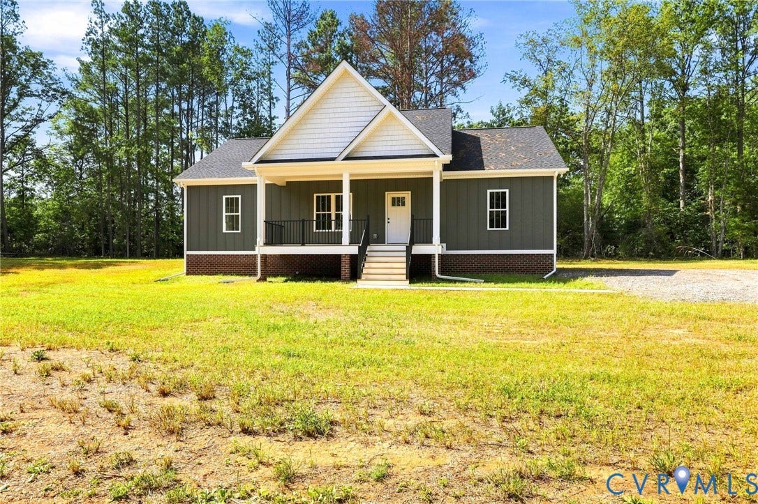 3289 Cumberland Road, Cumberland, VA 23040 Craftsman-style home featuring a covered front porch, white columns, dark siding, and a gabled roofline