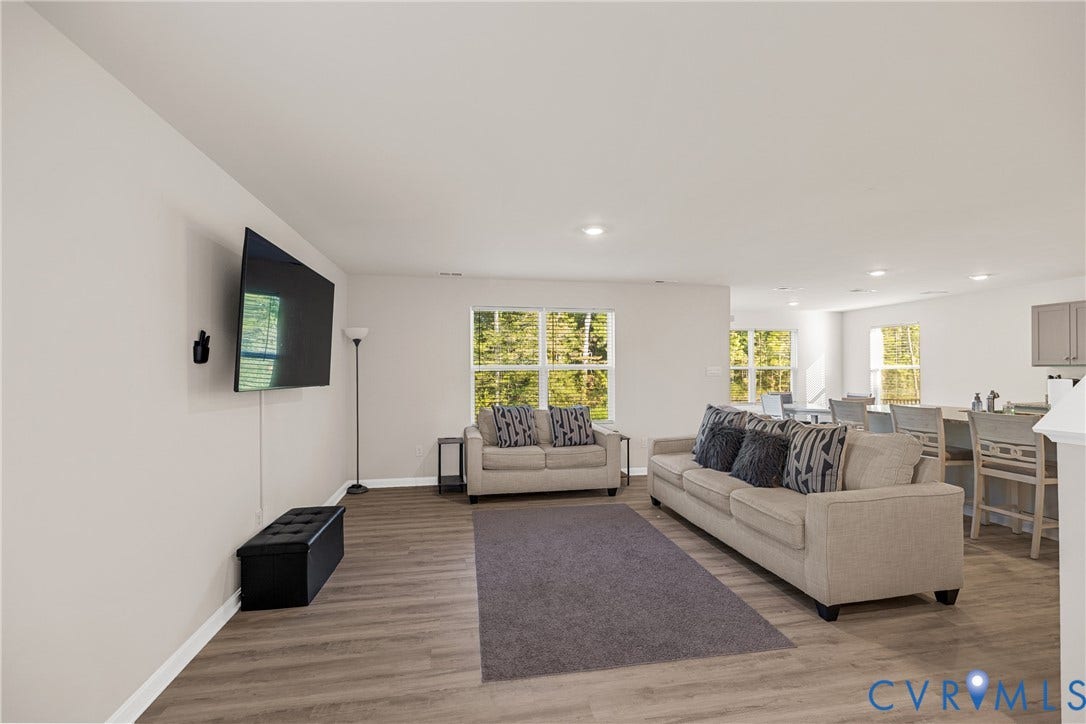 7974 Arbor Marsh Terrace, New Kent, VA 23124 Spacious living area featuring wood-finish flooring, recessed lighting, and multiple windows