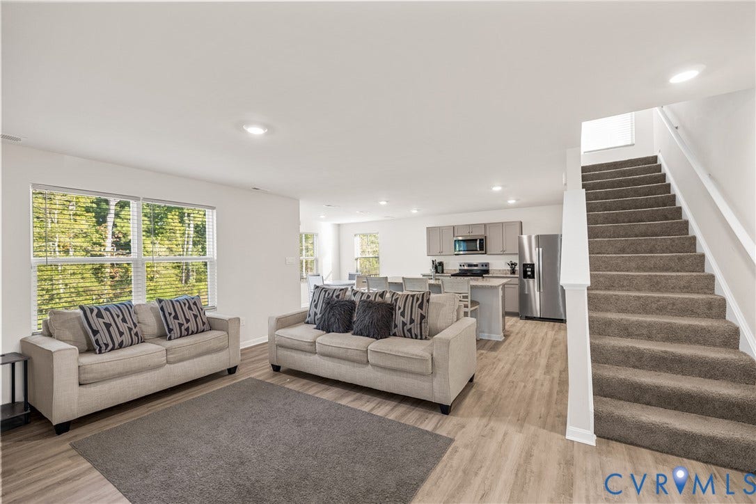 7974 Arbor Marsh Terrace, New Kent, VA 23124 Open concept living area featuring wood-finish flooring, recessed lighting, and a kitchen with stainless steel appliances