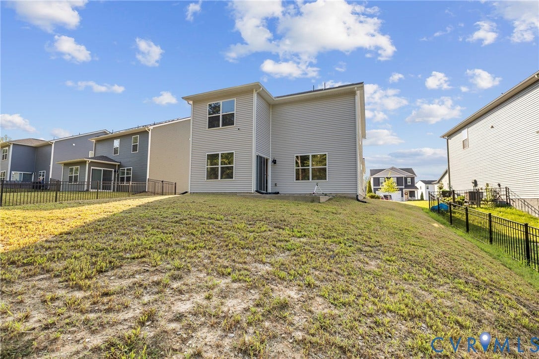 7974 Arbor Marsh Terrace, New Kent, VA 23124 Modern two-story residence with contemporary exterior featuring mixed siding finishes in neutral tones, large multi-pane windows, and a sloped roofline
