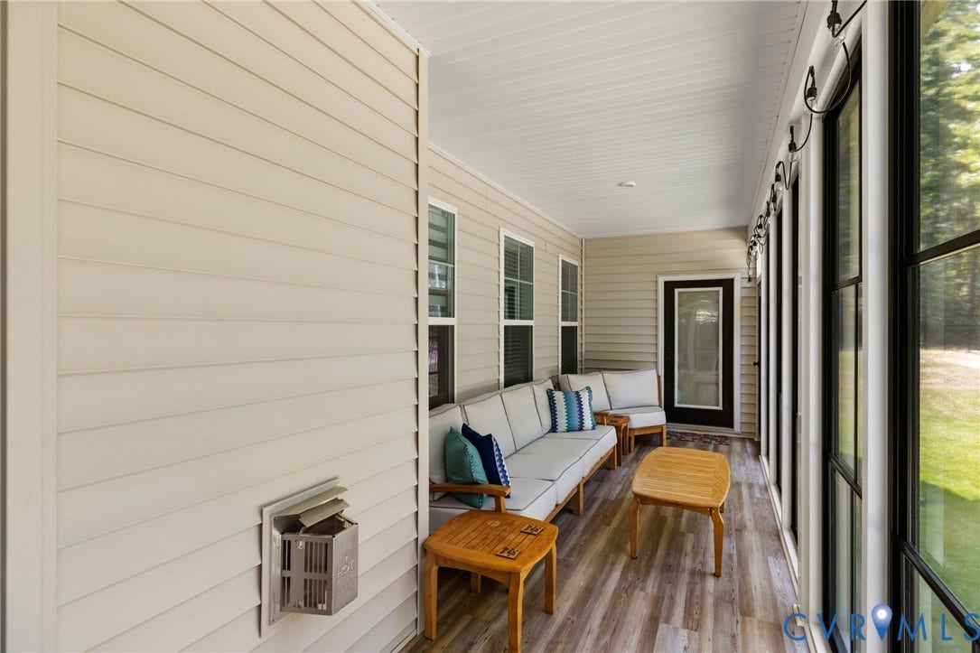 Screened porch featuring wood-finish flooring, white paneled ceiling, and multiple windows