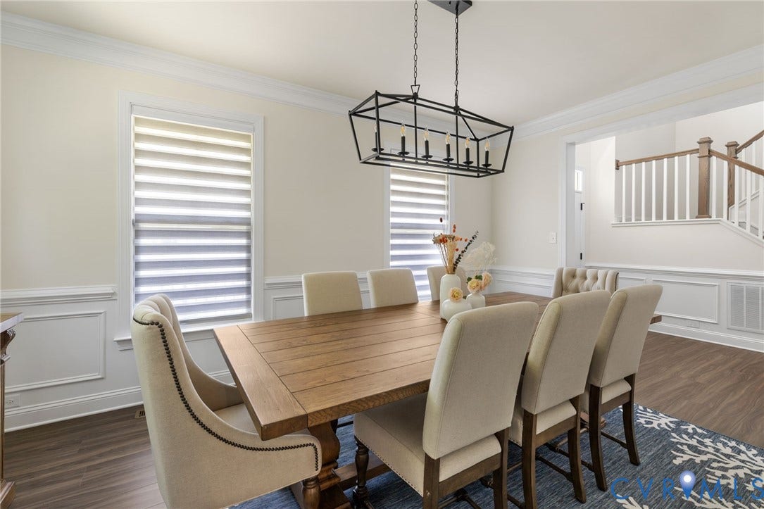 Wood-finish flooring, crown molding, and wainscoting details