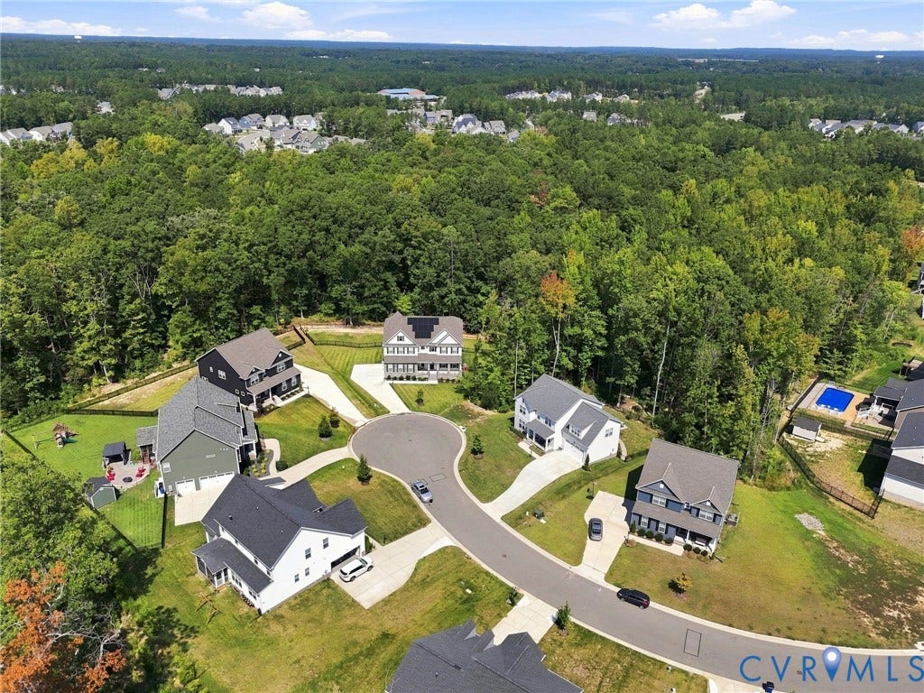 Residential development featuring cul-de-sac design, mature tree lines, and multiple single-family homes