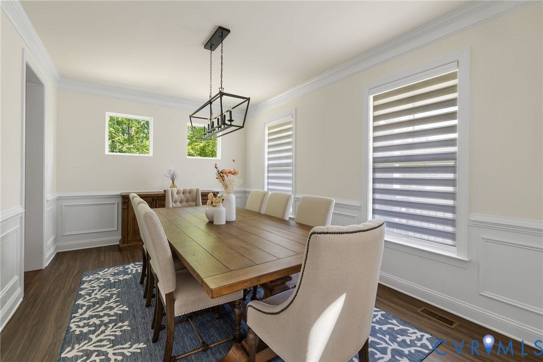 Wall paneling, crown molding, rectangular windows, wood-finish flooring, and a linear chandelier
