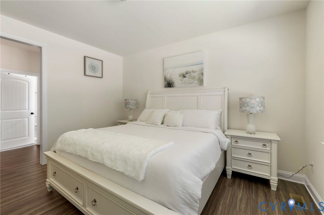 Wood-finish flooring throughout, white paneled interior doors, and neutral wall finishes