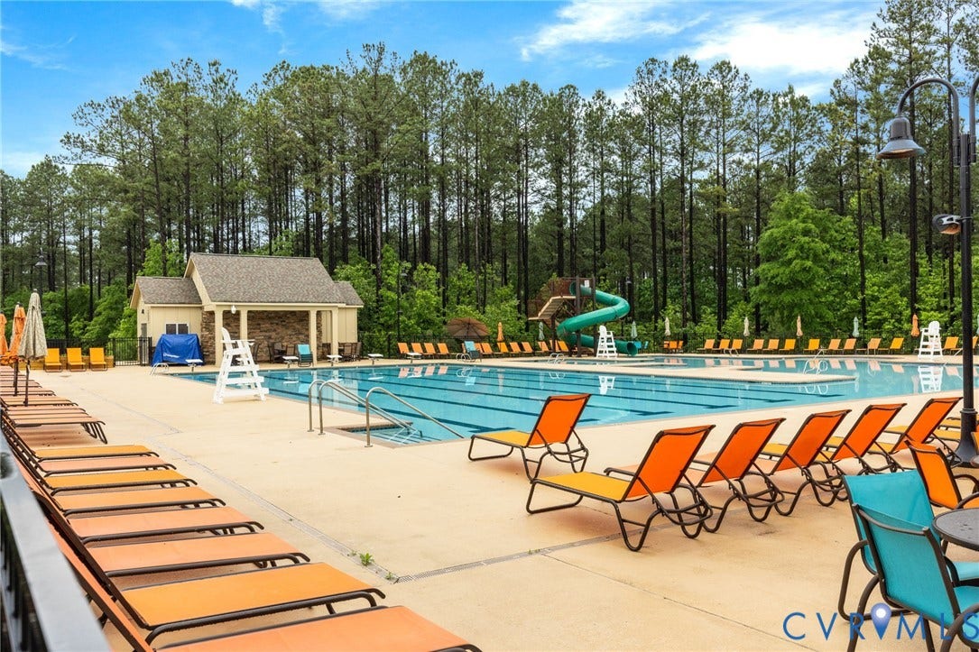 Expansive outdoor pool with integrated water slide and sun deck